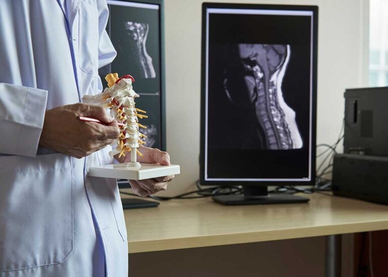Person seated in a quiet care setting while discussing neck tension and stress with a clinician.