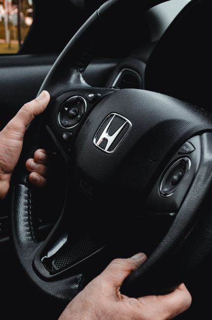 Driver seated with supported posture, relaxed shoulders, and hands comfortably positioned on the steering wheel.